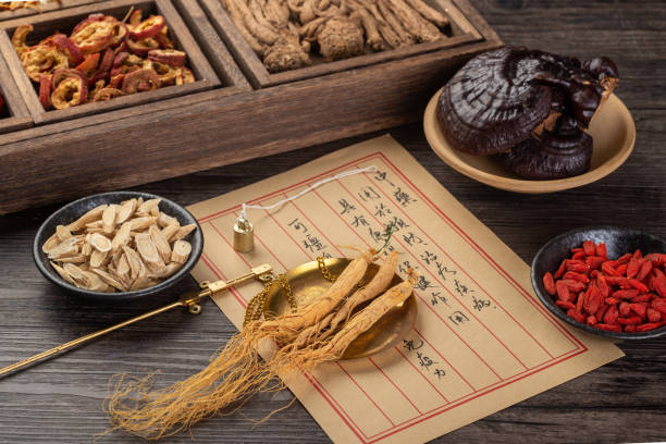 istock Ancient Chinese medicine books and herbs on the table 1339651387