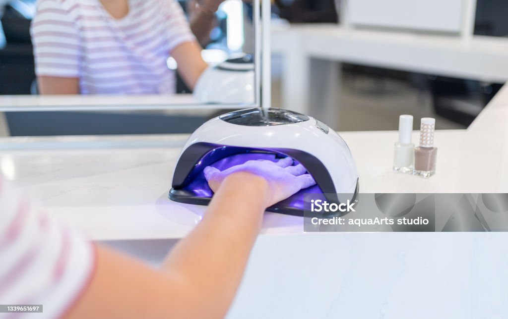 Female Customer Putting Hand İnto UV Lamp Dryer İn Beauty Salon Nail Polish Stock Photo