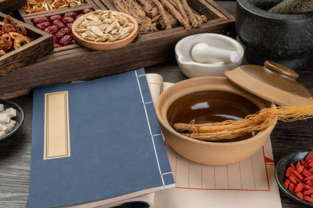 istock Ancient Chinese medicine books and herbs on the table 1339652562
