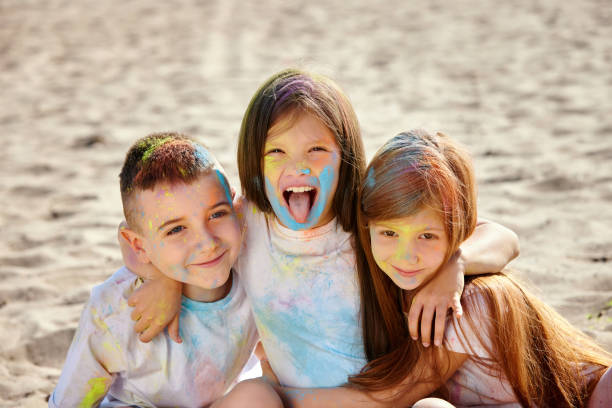 istock kids having fun by playing with colored powder 1339652588