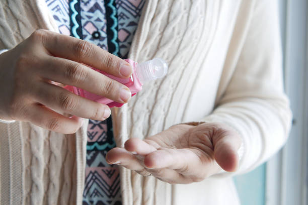 istock young women using hand sanitizer with copy space 1339653677