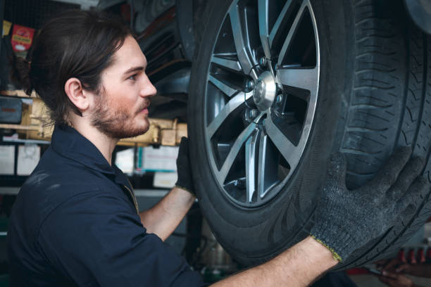 istock Auto mechanic work in garage, checking wheels, car service technician repairing customer car at automobile service center, inspecting car under body and suspension system, vehicle repair service shop 1339655109