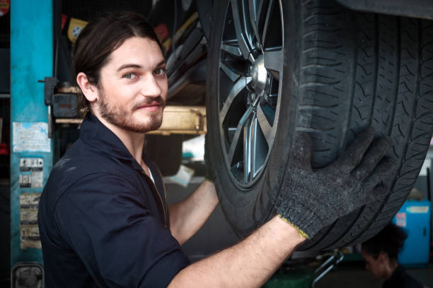 istock Auto mechanic work in garage, checking wheels, car service technician repairing customer car at automobile service center, inspecting car under body and suspension system, vehicle repair service shop 1339655121