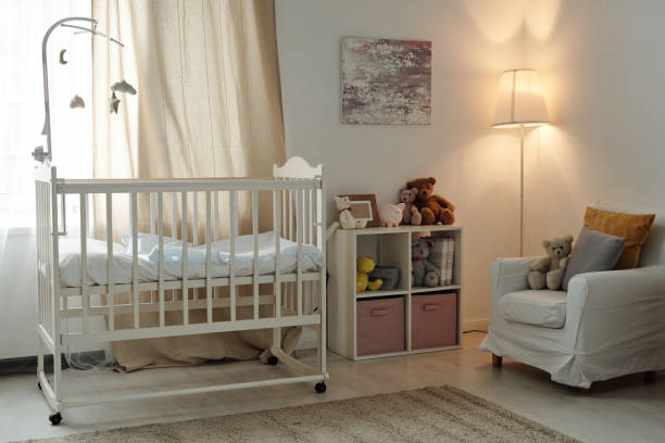Interior of large contemporary room of baby with cradle and furniture stock photo