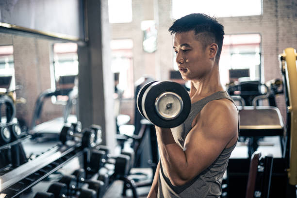 istock man doing exercise with dumbbell in gym 1339657851