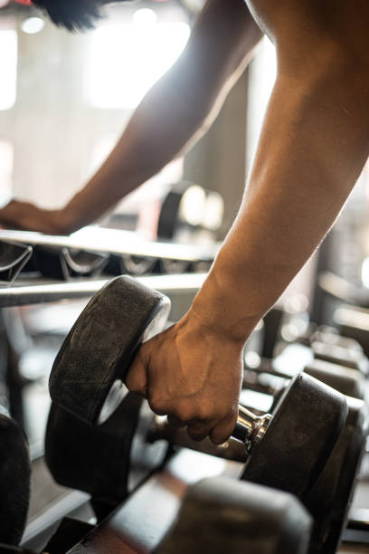 istock Man taking weights from in a gym 1339658848