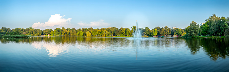 Large panorama of a city lake during a summer afternoon