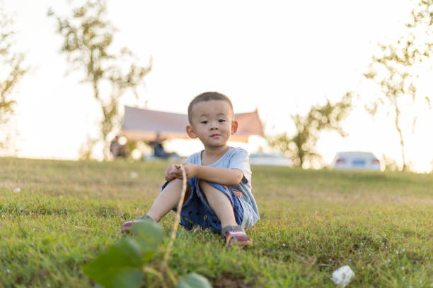 Two-year-old Chinese boy playing on the lawn