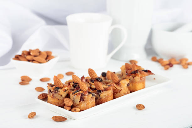 Small cakes with almonds, raisins, and honey on a white table.