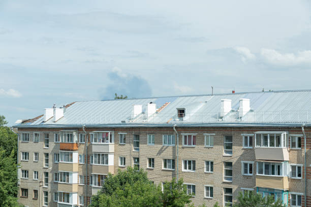 A five-storey building with a new roof replaced by a profiled sheet