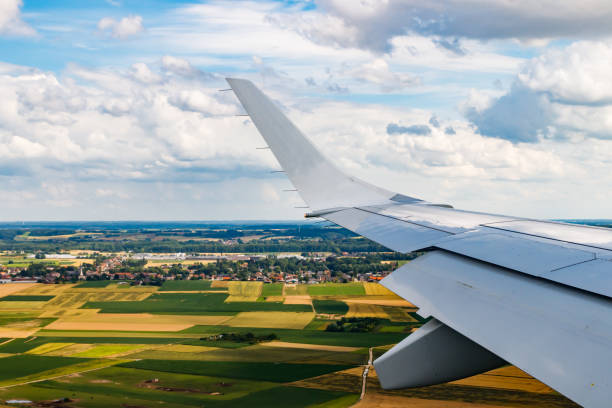 istock Plain wing over Belgium. Flight from Amsterdam to Brussels. 1339669236