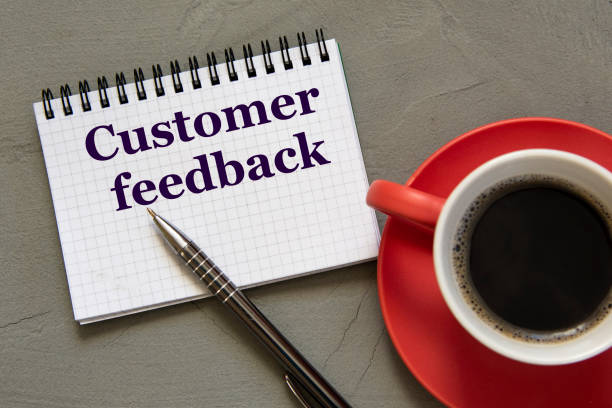 istock CUSTOMER FEEDBACK - words in a white notebook on a gray background with a pen and a cup of coffee 1339670447