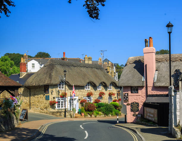 Chocolate Box Photo of a quaint village with thatched cottages stock photo