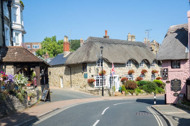 People outside the Red Lion pub at Avebury in Wiltshire, UK