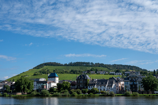 View on Mosel river, hills with vineyards and old town Traben-Trarbach, Germany