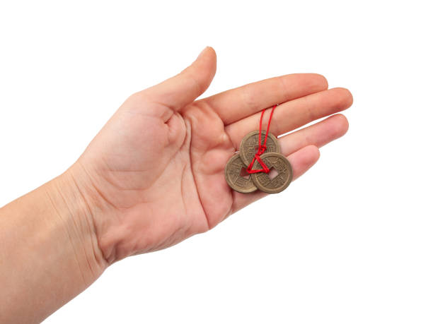 istock Chinese coins in hand isolated on the white 1339674537