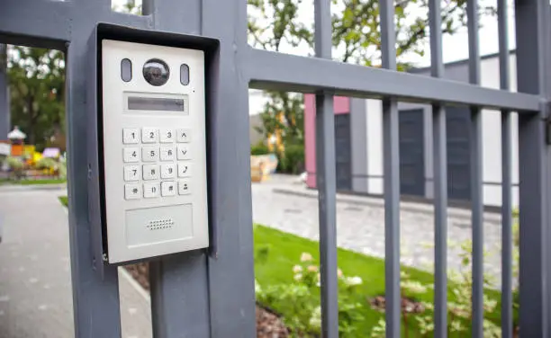 Photo of Video intercom on the gate at the entrance to the residential area. Electronic intercom to a private area. closed residential yard
