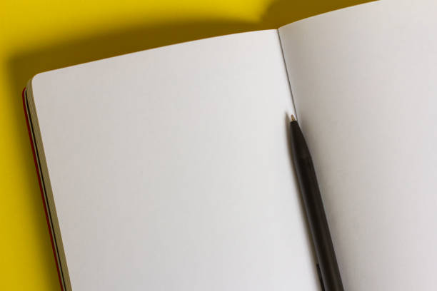 istock An open, clean notebook or notebook and a pen on the table.Close-up. 1339676639
