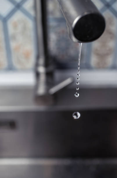 istock Drops of water from the mixer drip into the kitchen sink. 1339677942