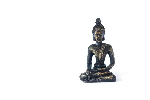 Statue of sitting in meditation Buddha isolated on white background
