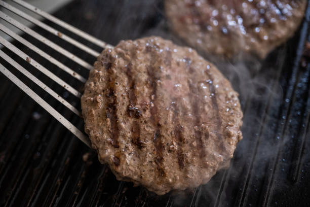 istock cooking beef patties on grill 1339682131