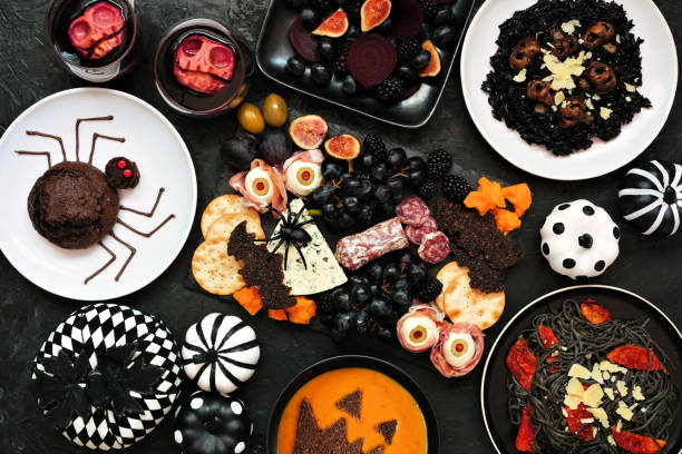 istock Halloween dinner party table scene over a black background 1339685248