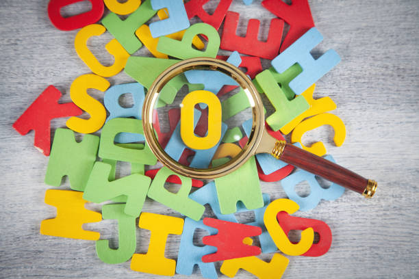 istock Magnifying glass with a colorful letters. 1339686665