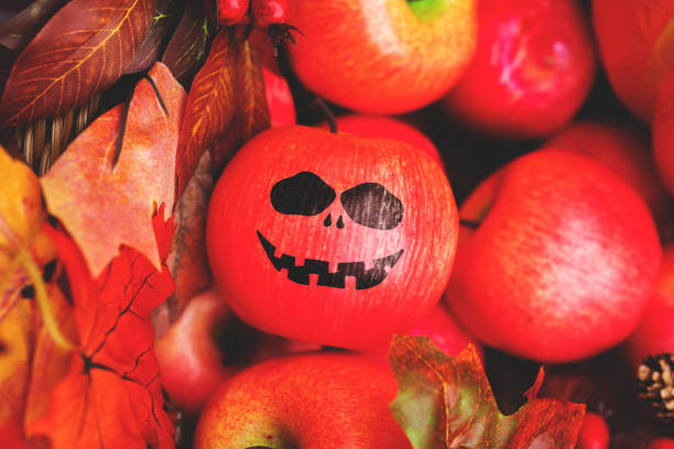 istock Cheerful face painted on an apple. Halloween holiday. 1339687786