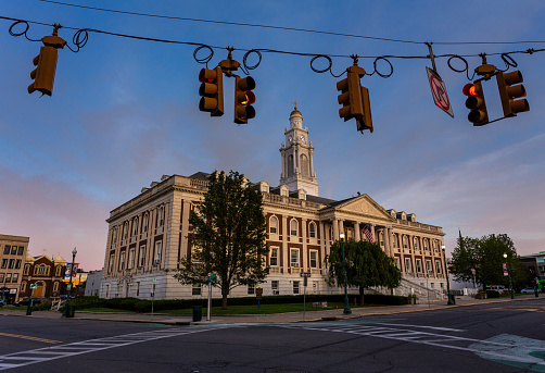 Schenectady, New York, USA — August 3, 2021: Traffic lights frame  City Hall in Schenectady, New York