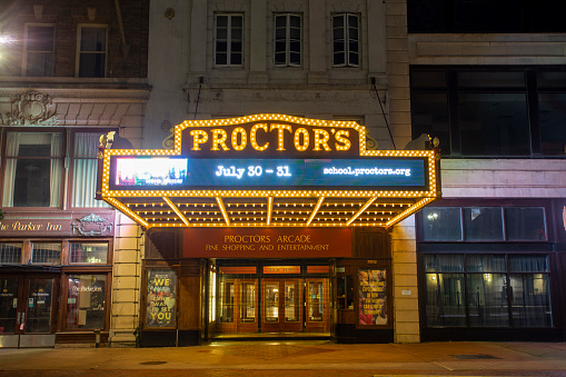 Schenectady New York, USA — August 3, 2021: The marquee of Proctor's Theater, a local Schenectady landmark, lights up State Street.