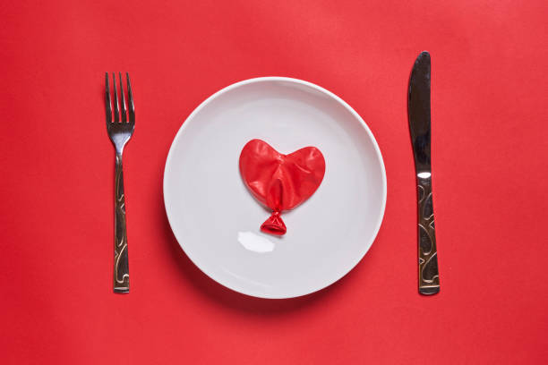 istock Eating love. Heart shape balloon eating 1339695237