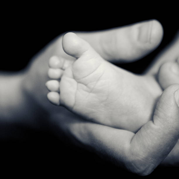 istock Father's Hand Holding Baby Foot 133969707