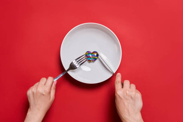 istock Eating love. Heart shape balloon eating 1339697571