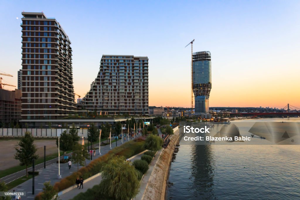 Belgrade waterfront with residential buildings and a Belgrade tower under construction Belgrade on water at sunset; modern architecture Belgrade - Serbia Stock Photo