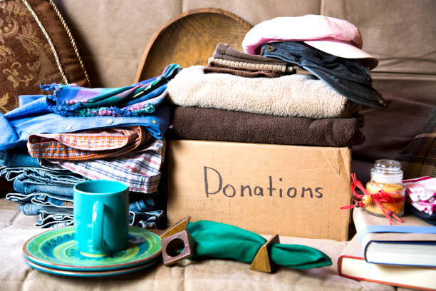 Gathering items to be donated to charity.  Items are placed on a futon that will also be donated. stock photo