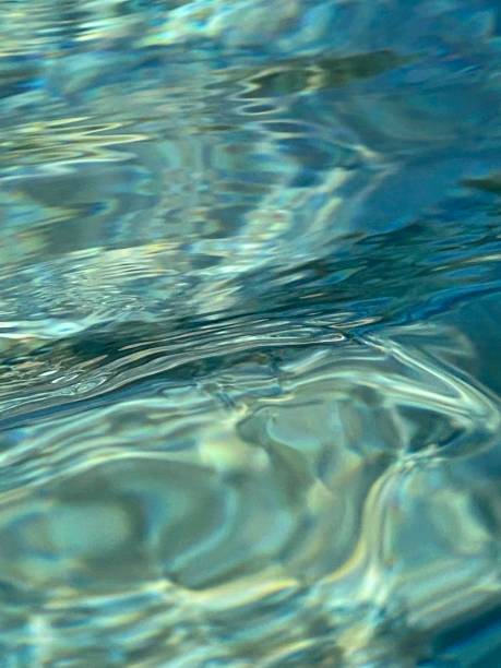 istock Light reflections on water surface of stone pool 1339697908
