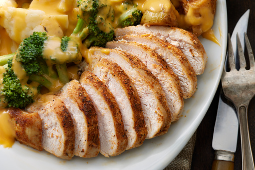Seasoned Chicken Breast with Roasted Potatoes and Steamed Broccoli with Cheese Sauce