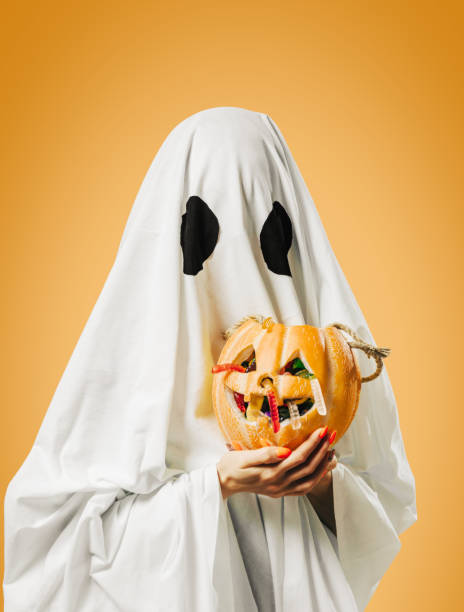 istock Ghost holding pumpkin basket with candy in Halloween. 1339699434