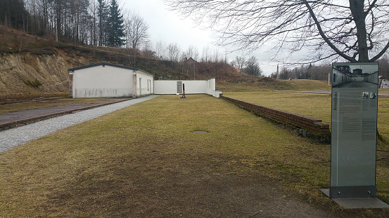 Flossenburg, Germany - February 24, 2020: Flossenburg Concentration camp memorial site. Detention barracks, prison and wall of the executions. Winter cloudy morning day