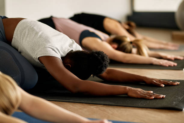 istock Group of female athletes stretching during group training in a gym. 1339701344