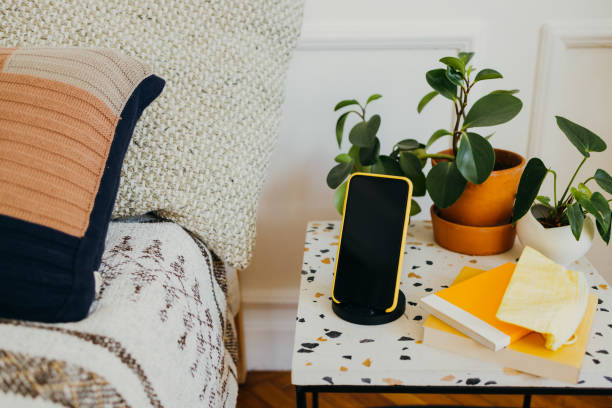 istock Phone by the Bed: a Smartphone Charging in on the Bedside Table 1339702787