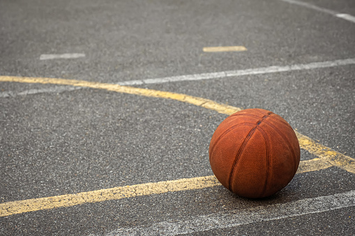 Basketball ball on the asphalt sports ground. Sports concept.