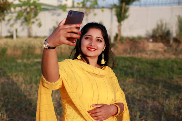 istock Pretty lady taking selfie using smart phone 1339716641