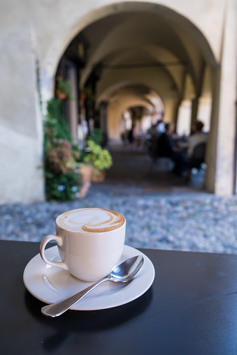 Cup of cappuccino on a table in a stylish exterior