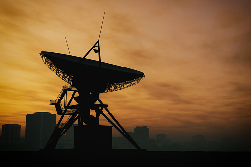 Giant radio telescope satellite dish at twilight.