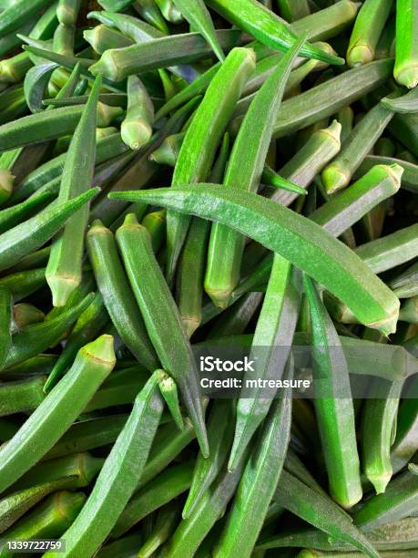 Full Frame Image Of Produce Market Pile Of Fresh Green Okra Being Sold At An Outdoor Fruit And Vegetable Market Elevated View Stock Photo - Download Image Now