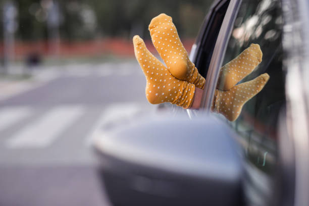 istock Girl resting feet on the car window 1339724623