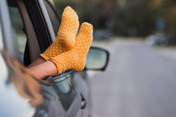 istock Girl resting feet on the car window 1339724629
