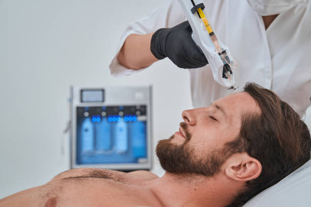 istock Patient getting a subcutaneous injection into his forehead with a mesogun 1339725462