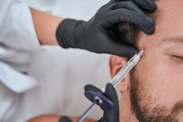 istock Male patient getting a face filler injection 1339725493